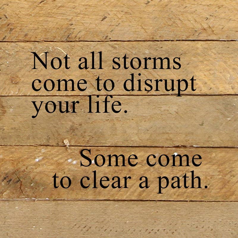 Reclaimed wood sign, natural finish with black text: “Not all storms…”