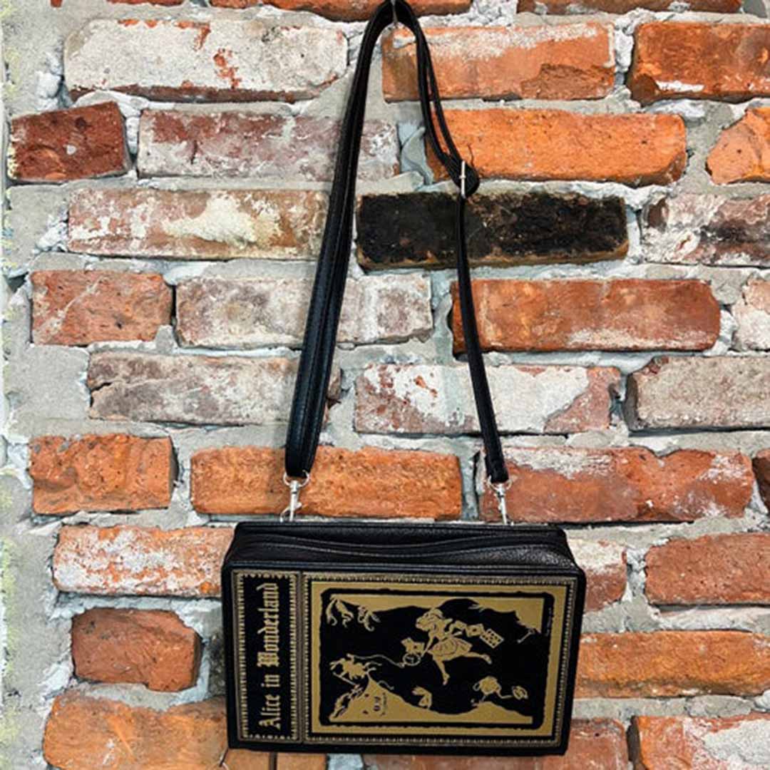 Alice in Wonderland storybook purse against brick wall