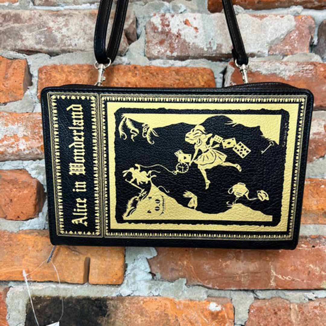 Alice in Wonderland storybook purse with graphic of Alice following down the rabbit hole