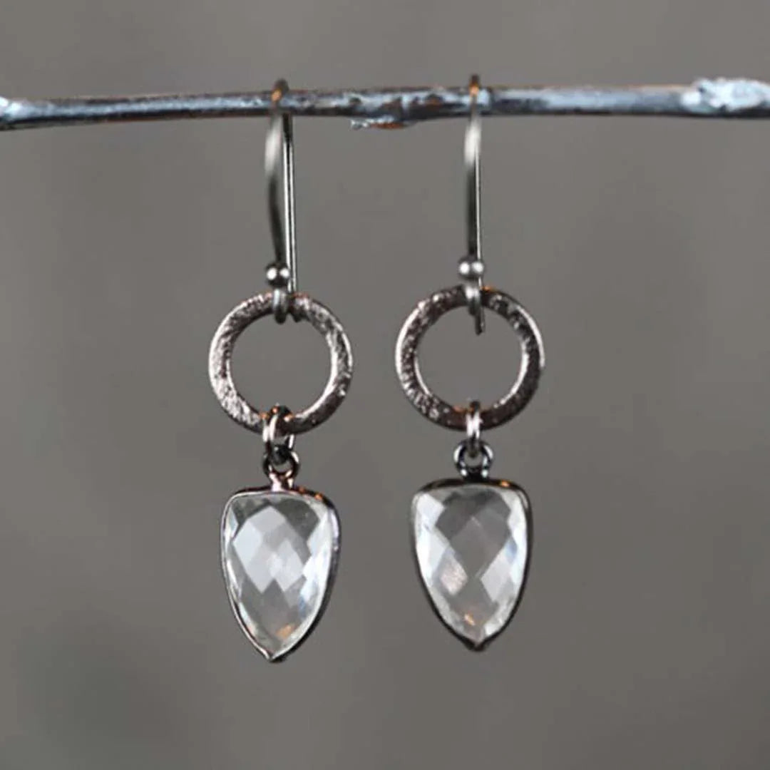 Brushed gunmetal hoop earrings with dangling heart crystal quartz drops