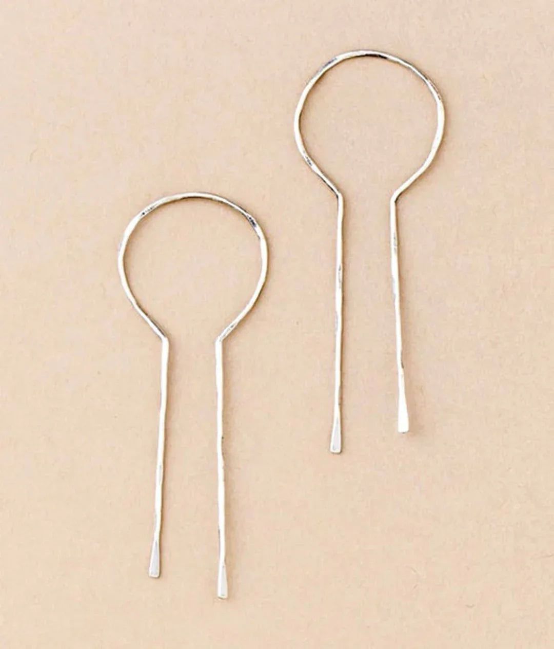 Sterling silver Equinox keyhole hoop earrings, close-up of dangling open keyhole hoops.