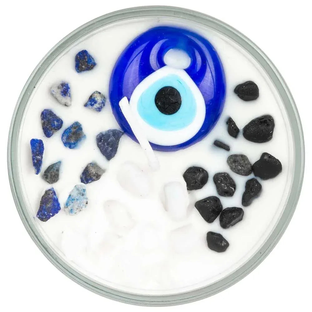 Evil eye candle top view in glass jar with blue and black decorative stones