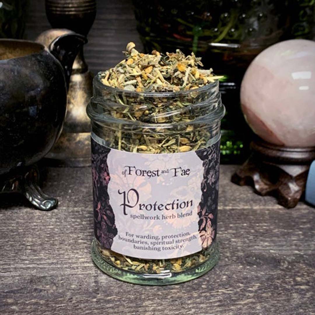 Protection spellwork herb blend in glass jar; label reads “Protection”