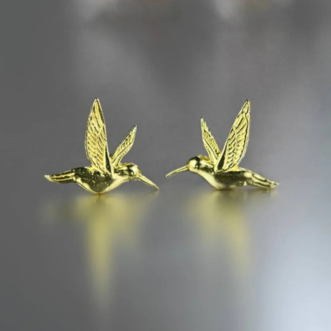 Gold hummingbird stud earrings with detailed wings