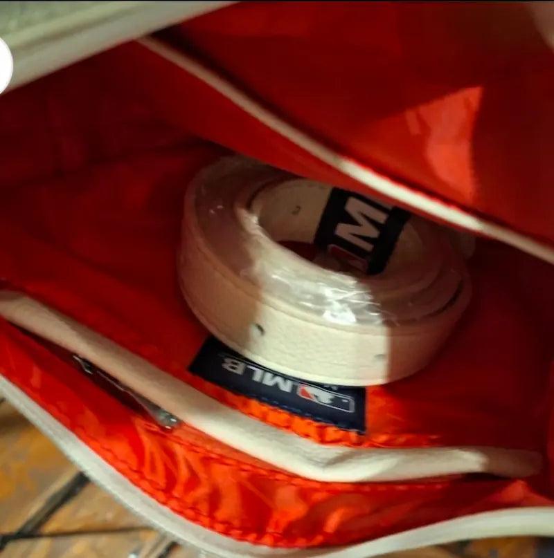 White hobo bag interior with red lining and black brand label patch