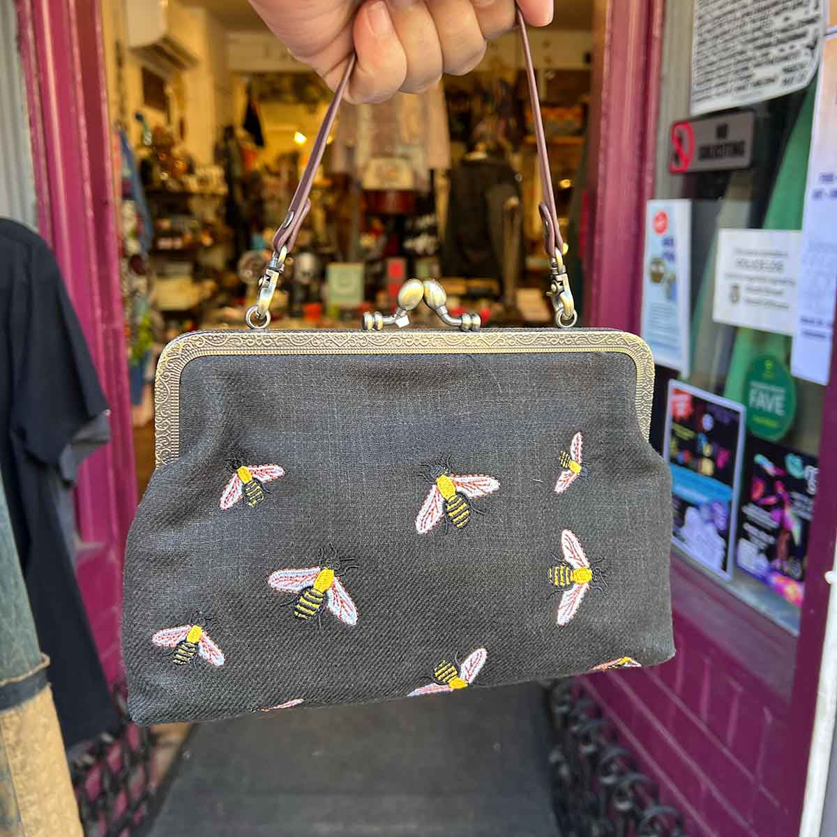 Timeless kisslock clutch bag with interchangeable chain crossbody strap, in black with embrodiered bumble bees