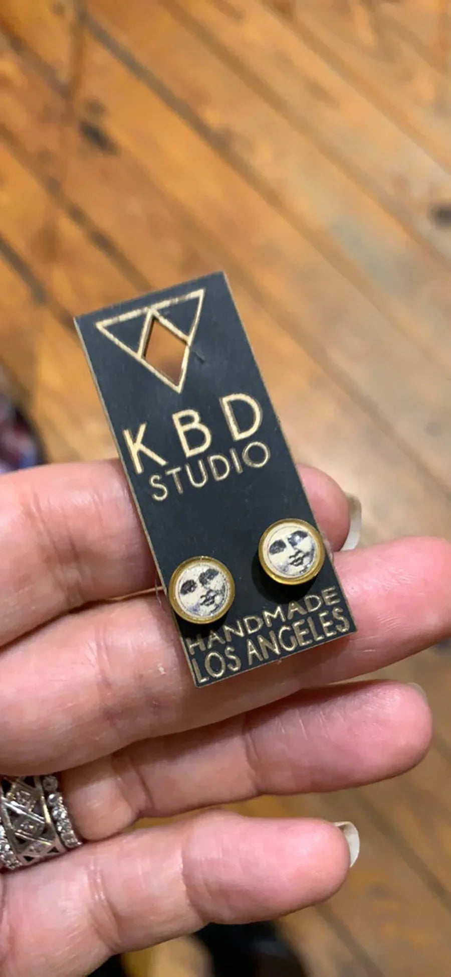 Man In The Moon studs in display card, gold round face earrings