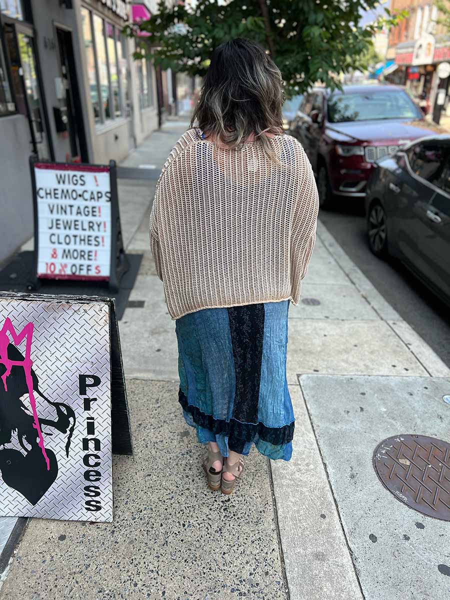 Back view of hi-lo sheer maxi skirt with tiered ruffles and elastic waistband; blue-green