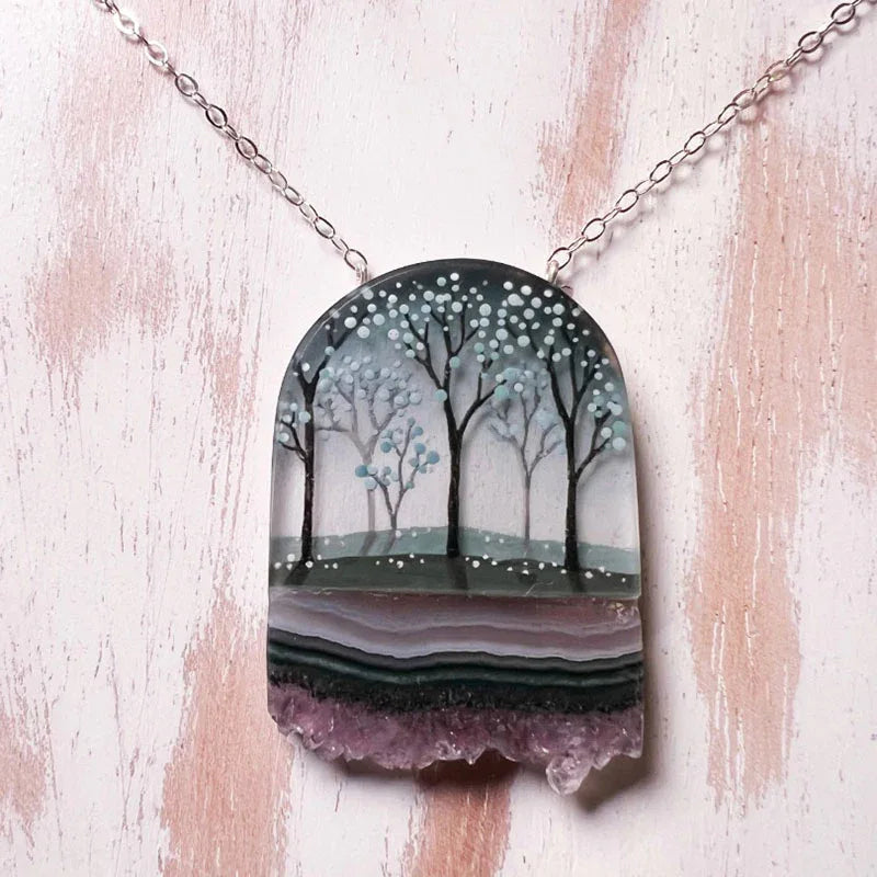 Handpainted Necklace: round pendant with pale trees, snowy dots, and purple crystal base
