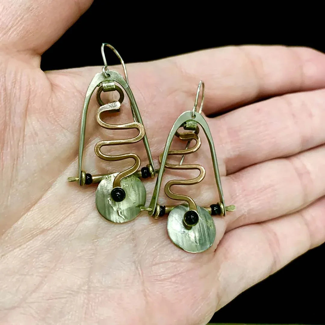 Squiggly mixed-metal onyx earrings with black center beads and greenish oval drops