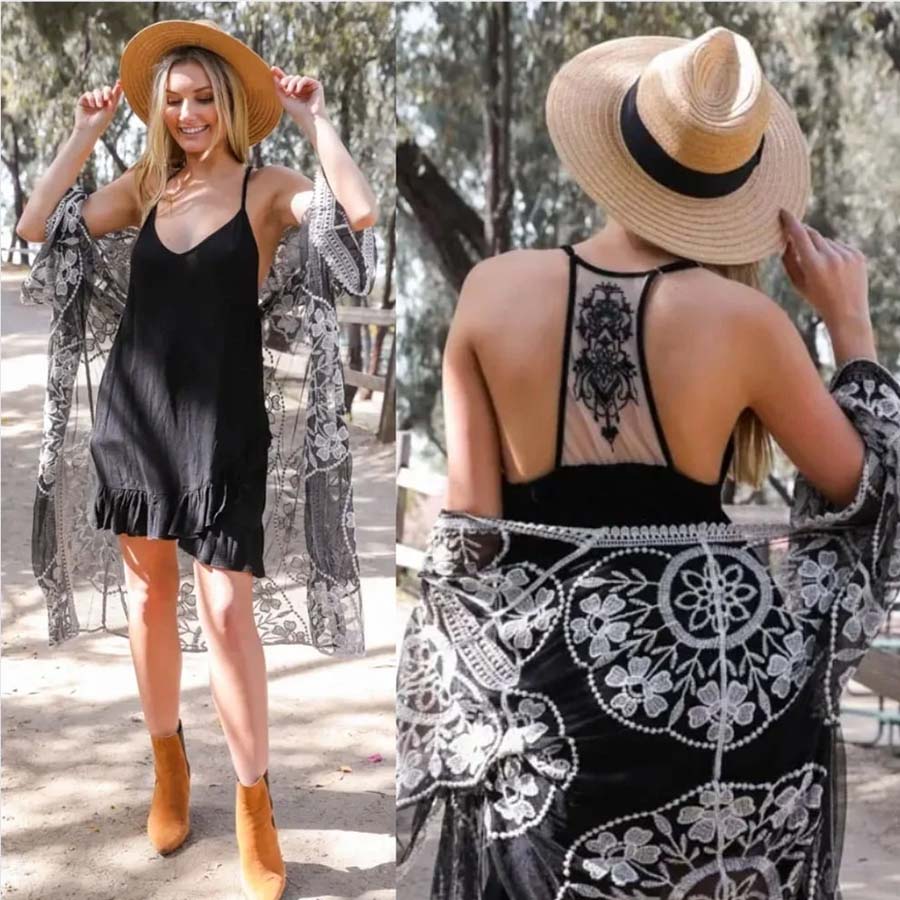 Black slip dress with ruffled hem and tattoo-style mesh back with floral print