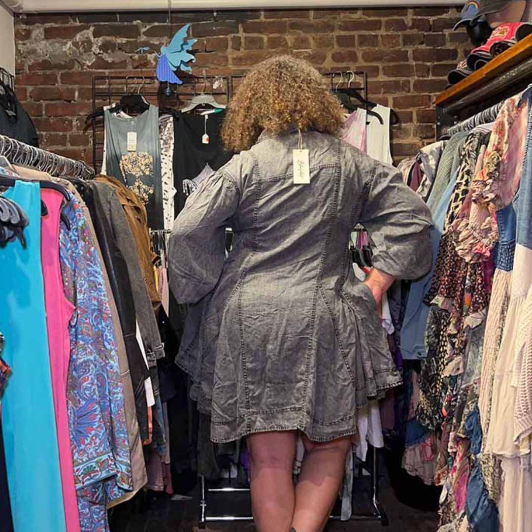 Model facing backwards hands in pocket