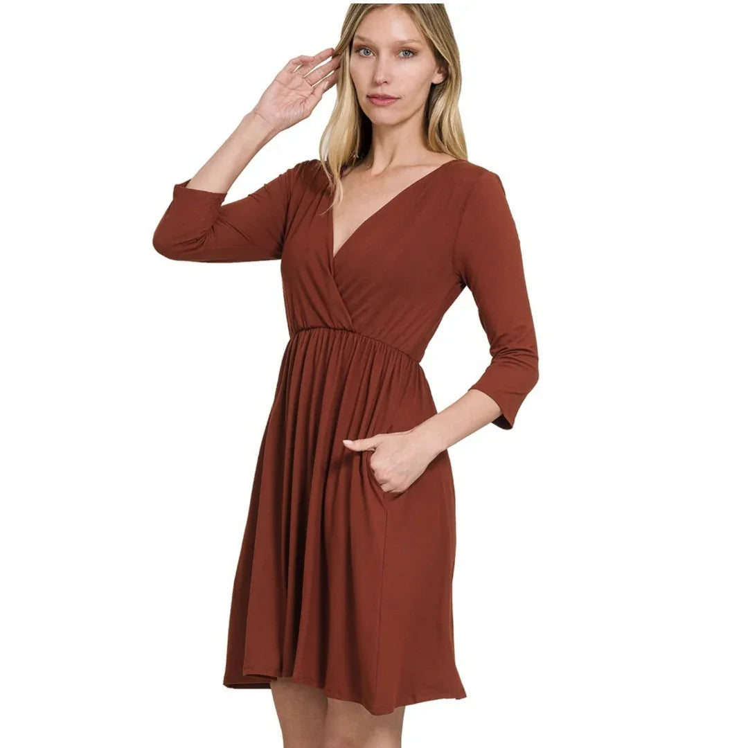 Rust V-neck dress with pockets, long sleeves and gathered waist