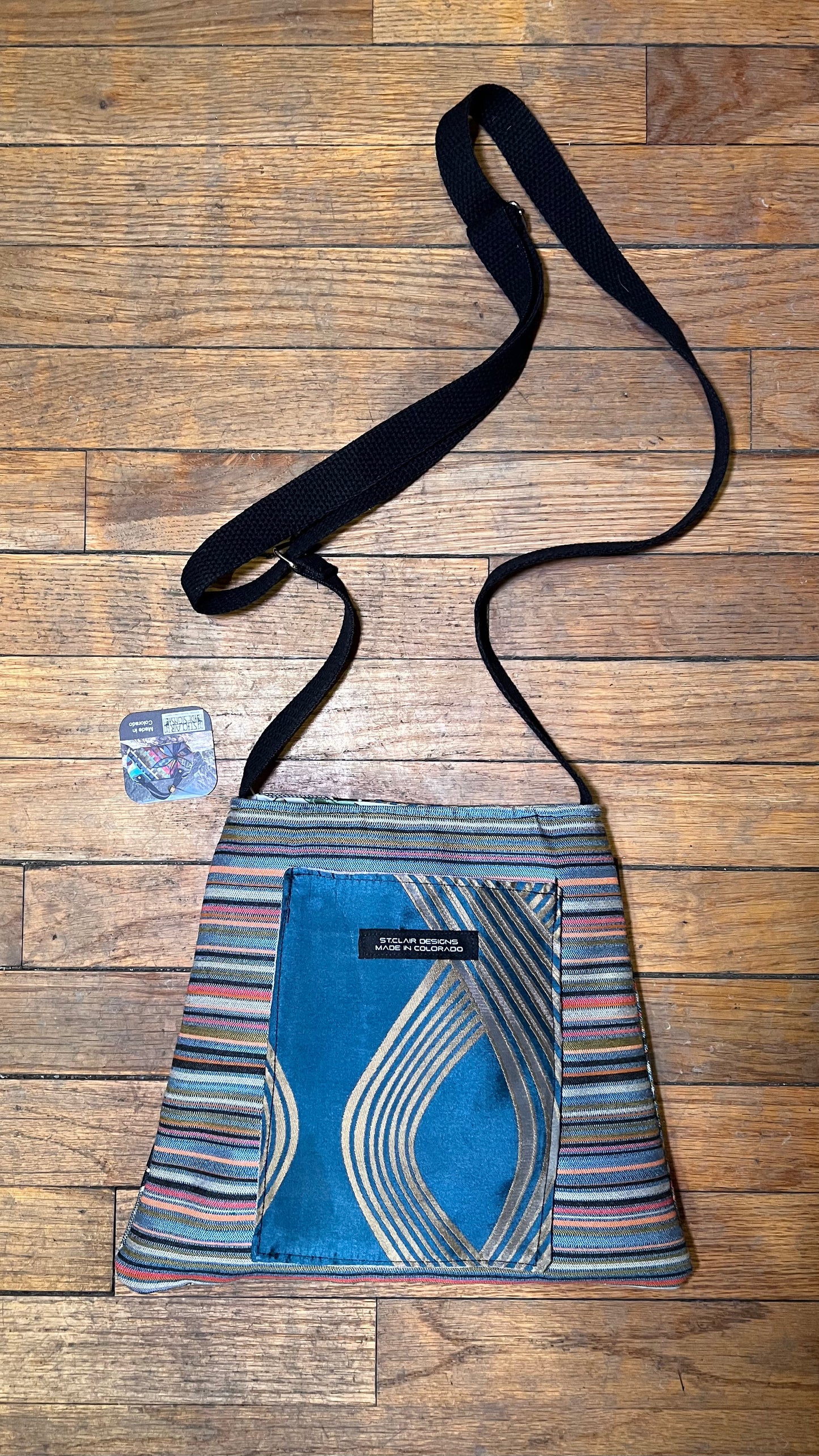 The Jackie Bag crossbody with blue geometric center panel and striped fabric sides