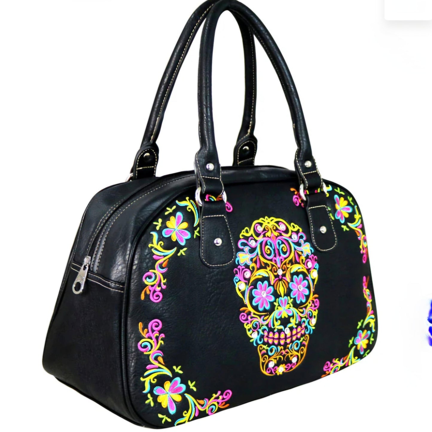 Black handbag with colorful skull and floral design on a white background