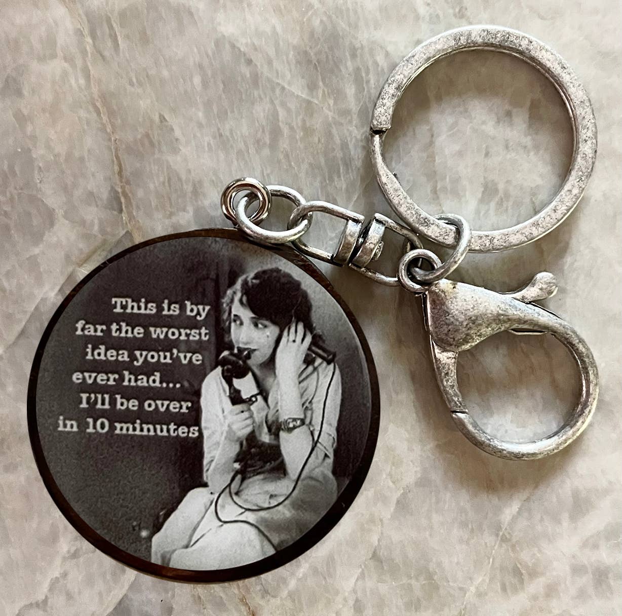 Keychai with picture of women on old phone saying, THis is by far the worst idea you'ce ever had...I'll be over in 10 minutes 