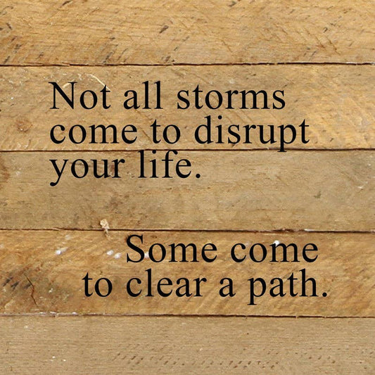 Reclaimed wood sign, natural finish with black text: “Not all storms…”