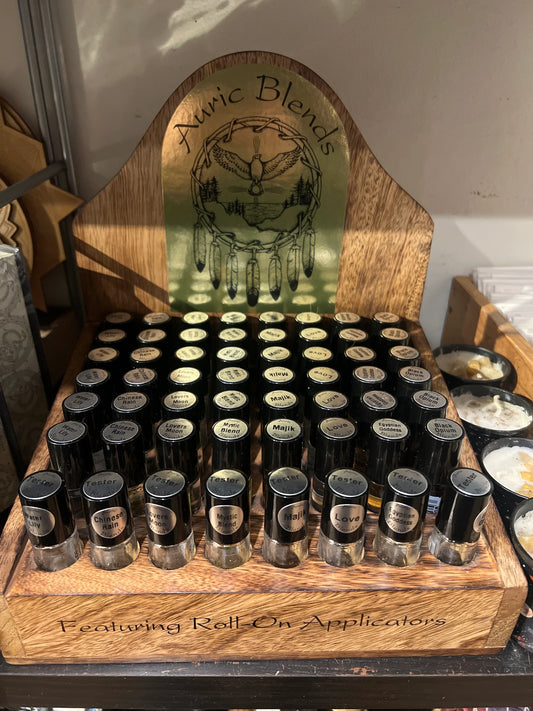 Perfume fragrance oil roll-on display with multiple small black-capped bottles