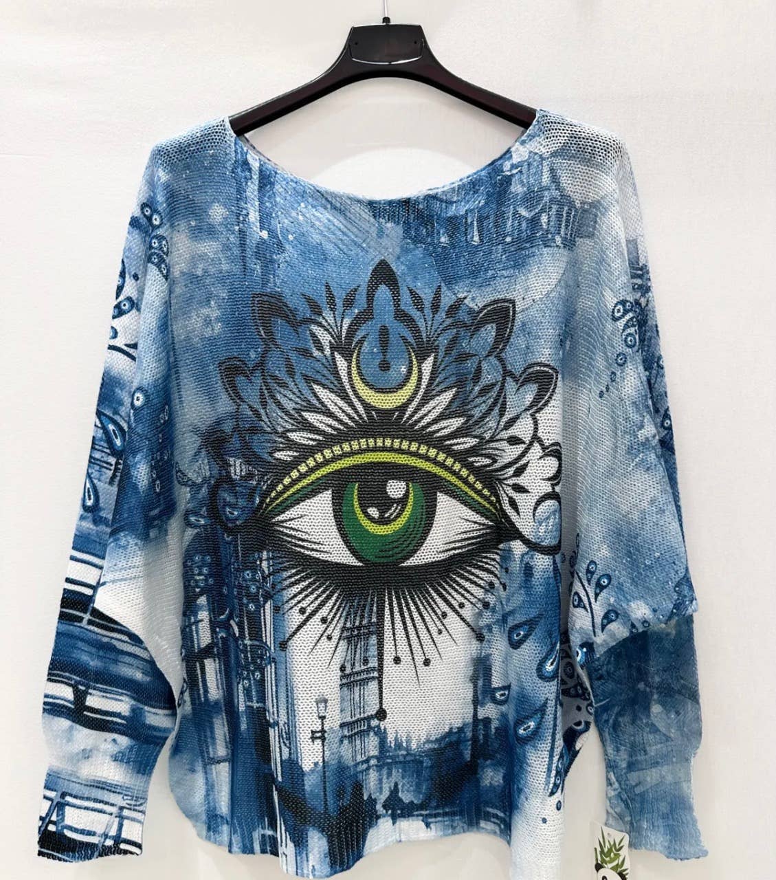 Light blue printed sweater with large green eye motif, long sleeves