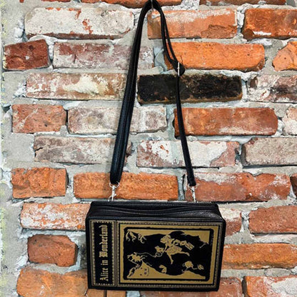 Alice in Wonderland storybook purse against brick wall