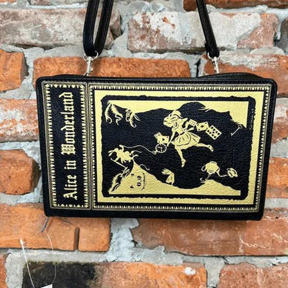 Crossbody Storybook Handbag with 'Alice in Wonderland' design on a brick wall background