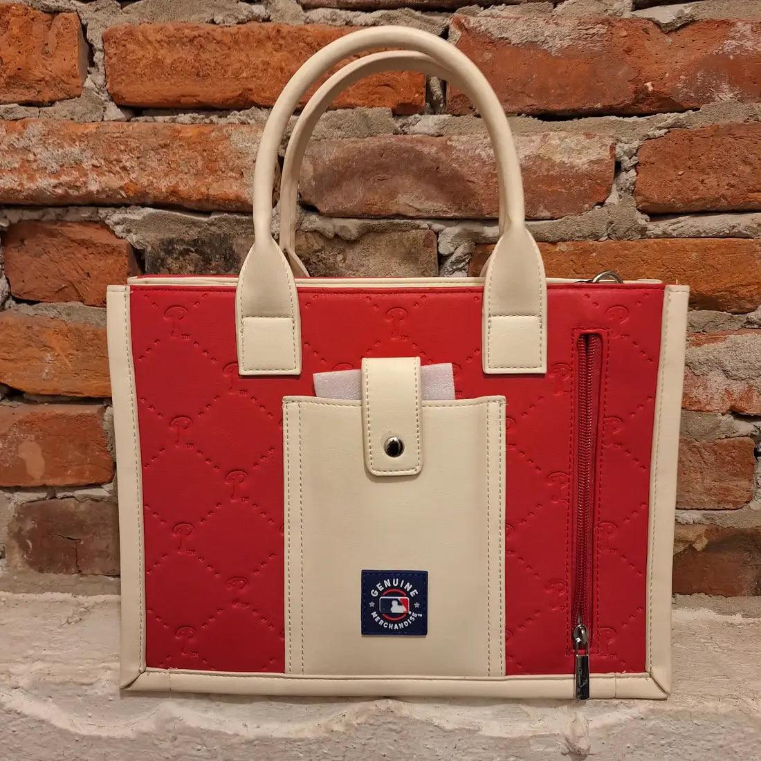 MLB Philadelphia Phillies tote bag  featuring a phone pocket with snap closure against a brick wall background