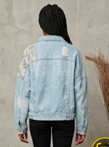 Back view of a Light blue denim jacket with super soft snakeskin patchwork sleeves worn by a person against a neutral background