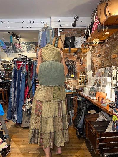 Olive patchwork maxi duster dress, back view with gathered hood and tiered panels