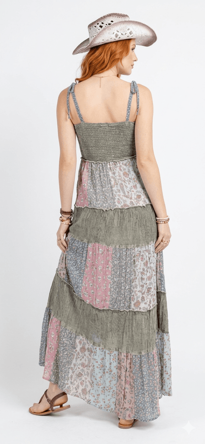 Boho tiered patchwork maxi sundress in earthy tones, styled with wide-brim hat - Cowboy vibes