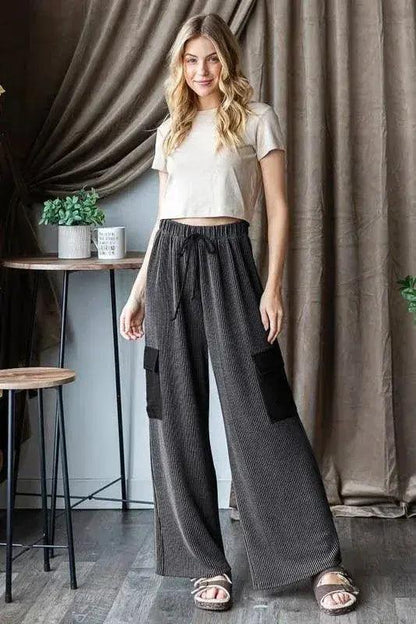 Cozy ribbed cargo pants from Mary Clothes featuring a relaxed fit, ribbed texture, and multiple pockets in neutral tones.