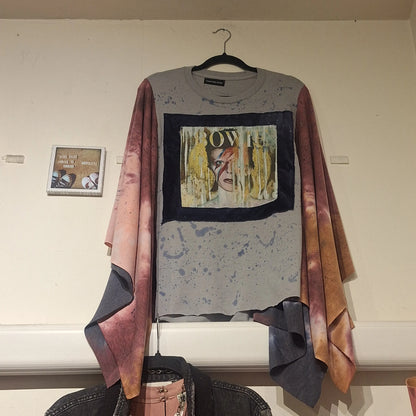 Custom made David Bowie poncho hanging on the wall next to a picture that says Run like a girl