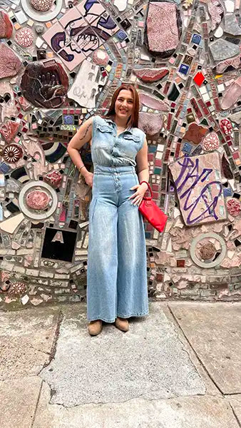 Light blue denim jumpsuit with sleeveless collared neckline, button front, long wide legs.