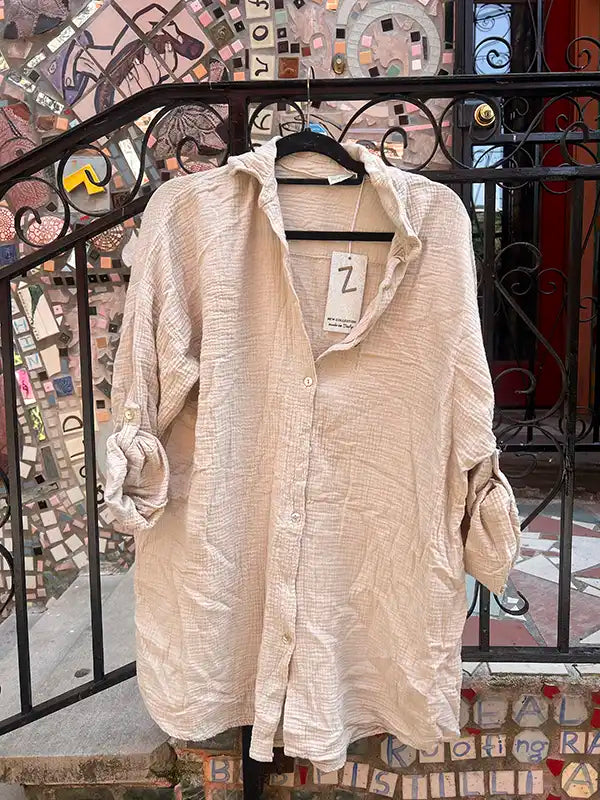 Beige shirt on a hanger with a colorful mosaic background