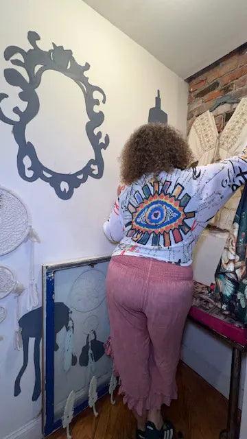 Light blue printed sweater with eye motif on back, long sleeves