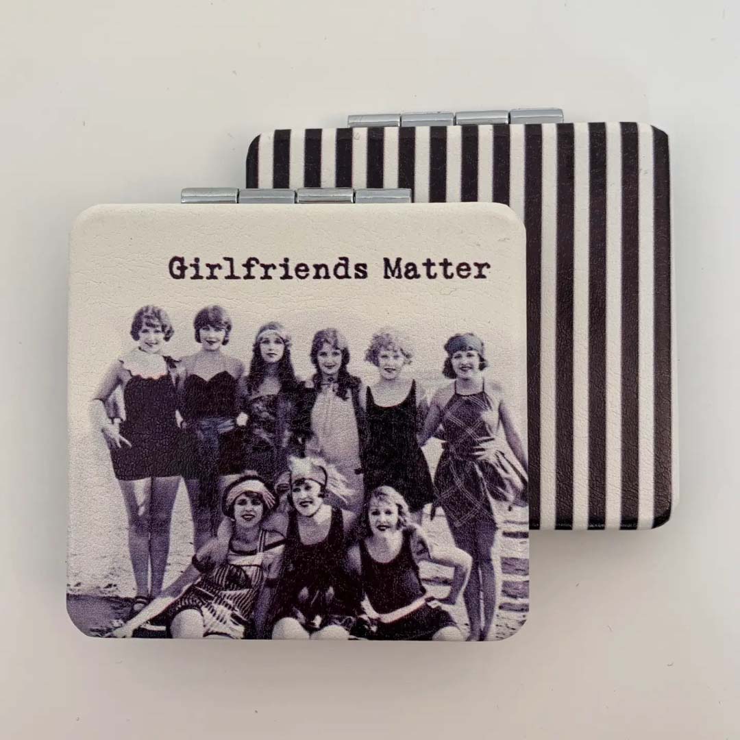 Compact mirror with vintage-style photo and 'Girlfriends Matter' text on a white background