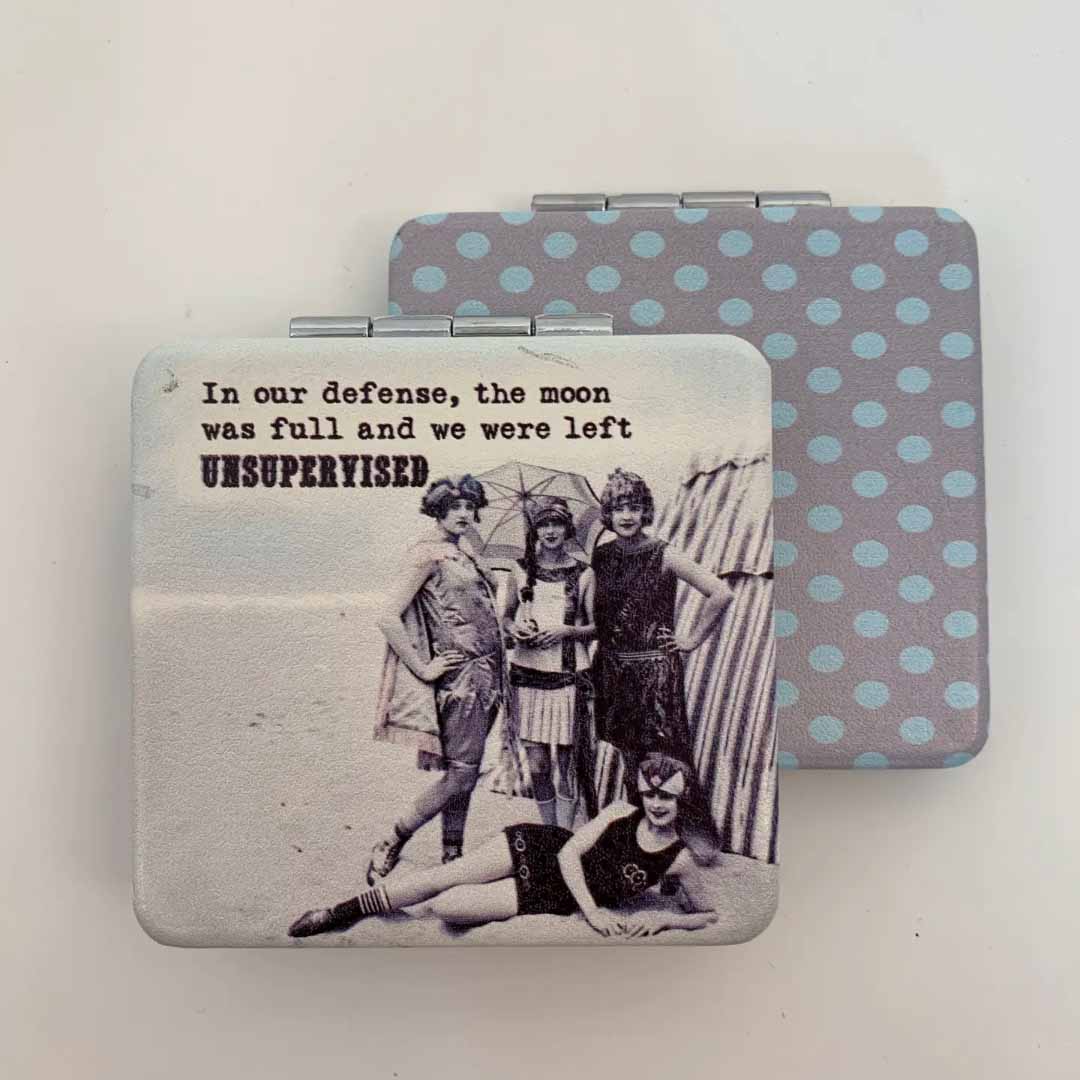 Compact mirror with vintage photo and humorous text on a light background