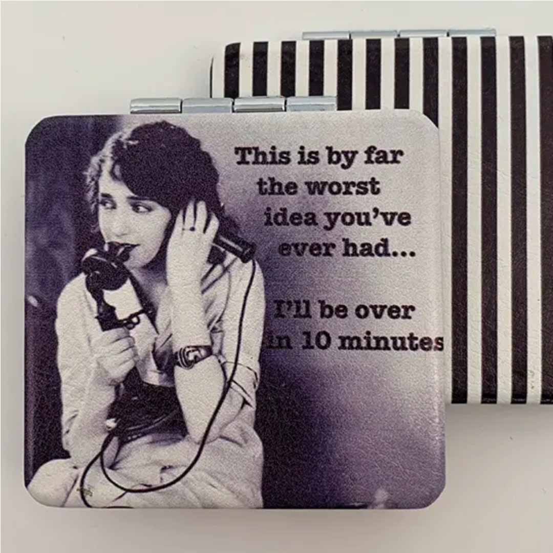 Compact mirror with black and white photo of a woman on the phone and humorous text.