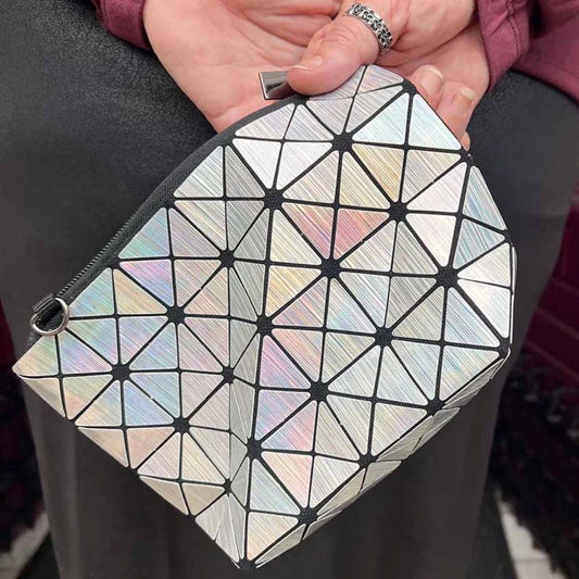 Hand holding silver holo purse