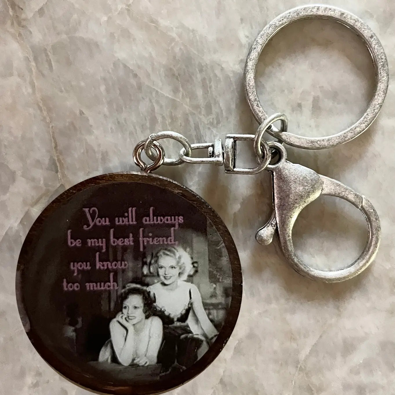 Keychain with vintage-style photo and text on a marble surface