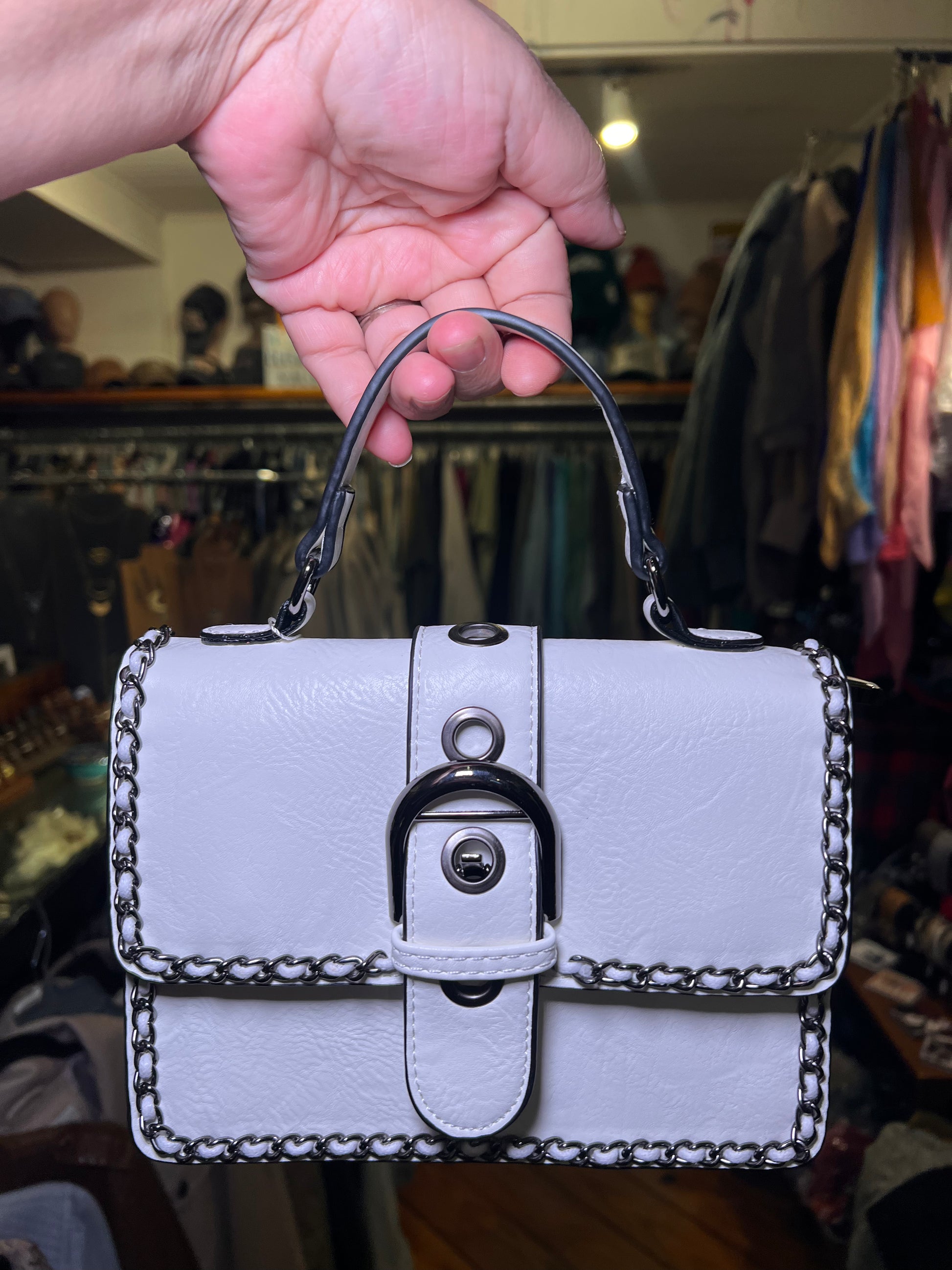 Chain-trimmed classic edge handbag, white faux-leather flap with lock clasp