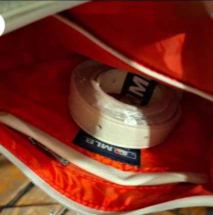 White hobo bag interior with red lining and black brand label patch