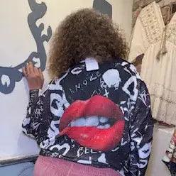 Graphic lips sweater, black with white lettering and skull-style prints