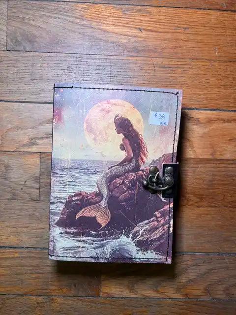 Spiritual journal cover with mermaid figure under full moon, metal clasp on right