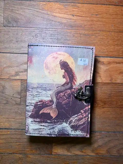 Spiritual journal cover with mermaid figure under full moon, metal clasp on right