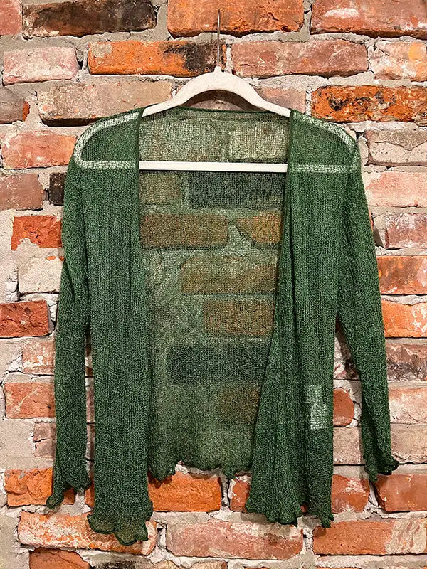 Green textured shrug with open front, long sleeves, and scalloped hem edge.