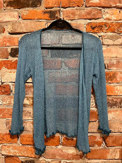 Teal textured shrug with open front, long sleeves, and scalloped hem edge.