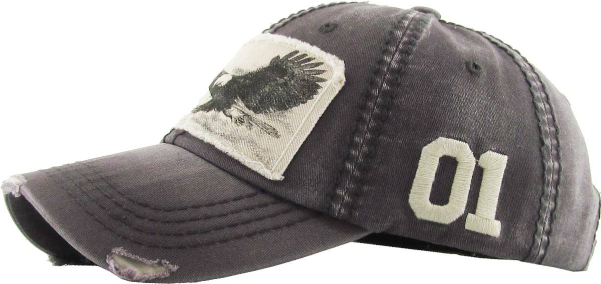 The side view of a distressed vintage ball cap with a picture of an eagle embroidered on. It is a worn Olive fabric. On a the eagles. background. Featuring the number one like Jalen hurts from