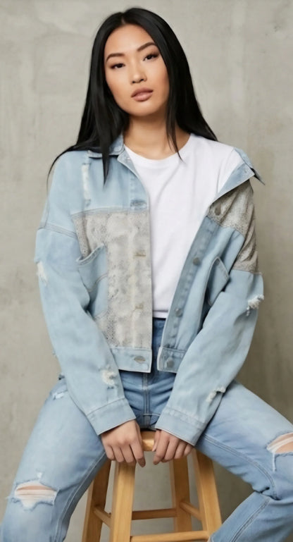 Oversized denim jacket with snakeskin patchwork, achieving a boho street style with the casual off the shoulder fit.