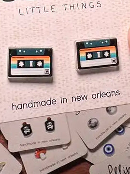 Tape cassette stud earrings on a Lilliput Little Things card with a hand holding it.