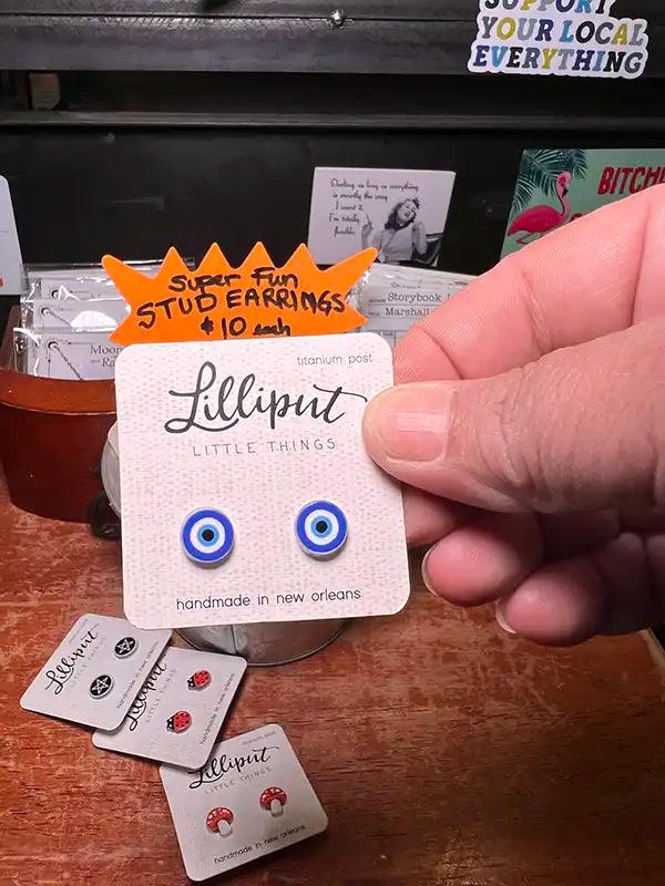 Novelty stud earrings with blue evil-eye disc charms